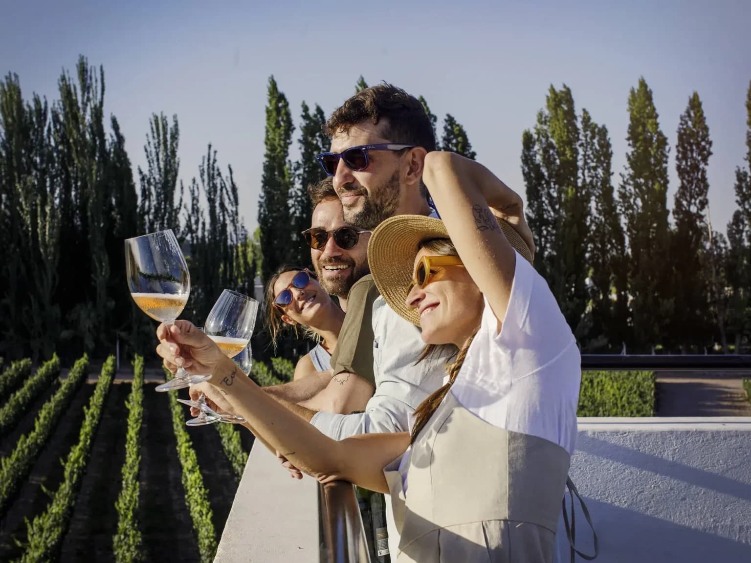 Friends enjoying wine on a Mendoza vineyard terrace